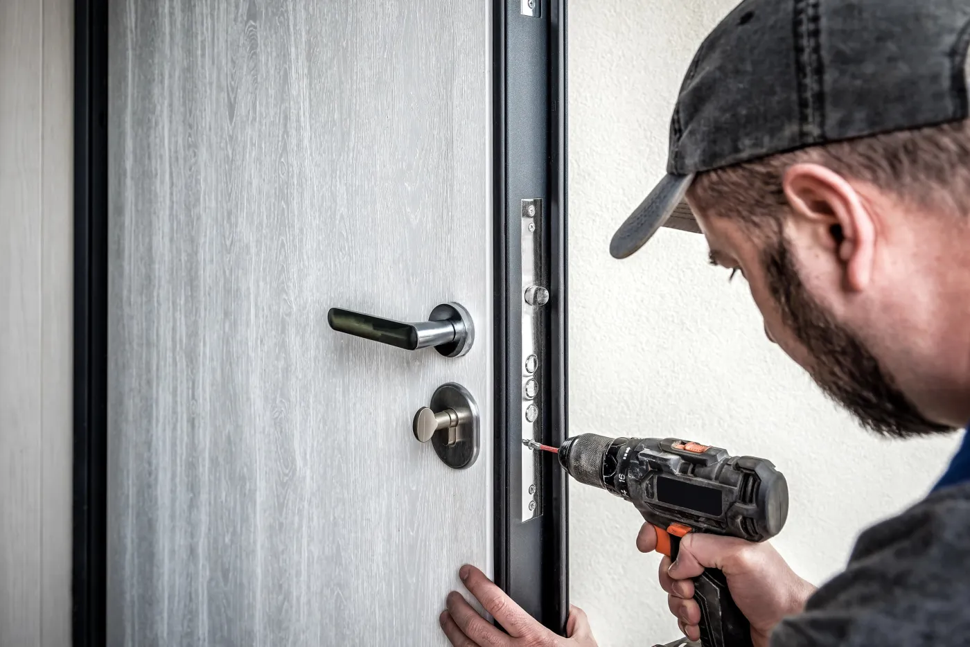 Installation d'une serrure sur une porte grise dans une résidence du 93